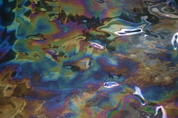 The oil still leaking from the USS Arizona in Pearl Harbor, Oahu, Hawaii. Taken before entering the remembrance hall. thumbnail