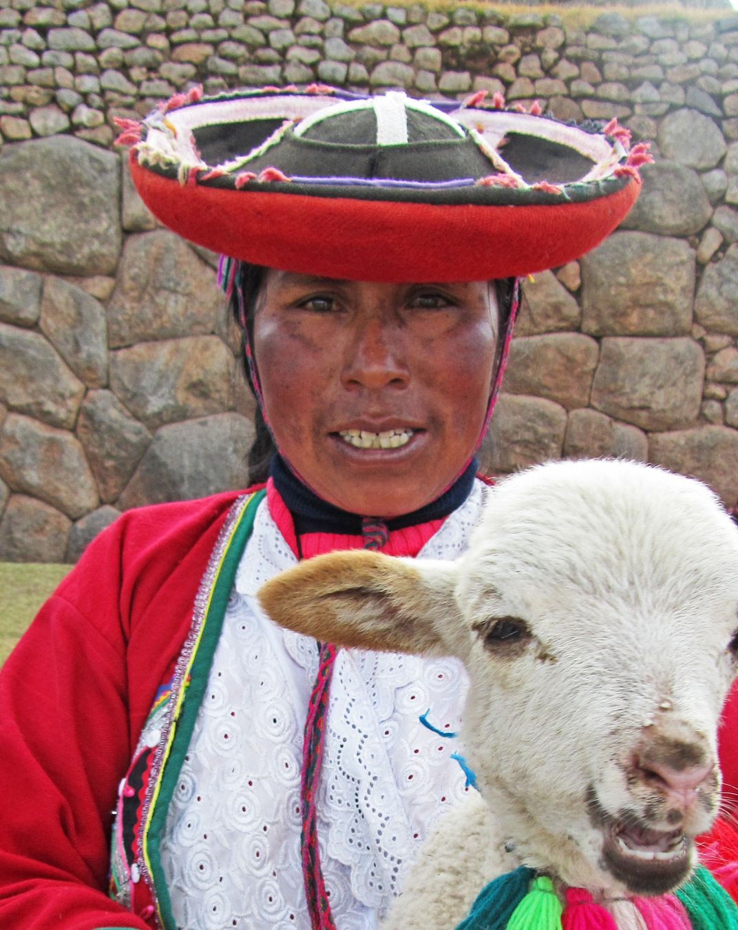 Andean woman in full dress with llama, outside of Saqsayhuaman ...