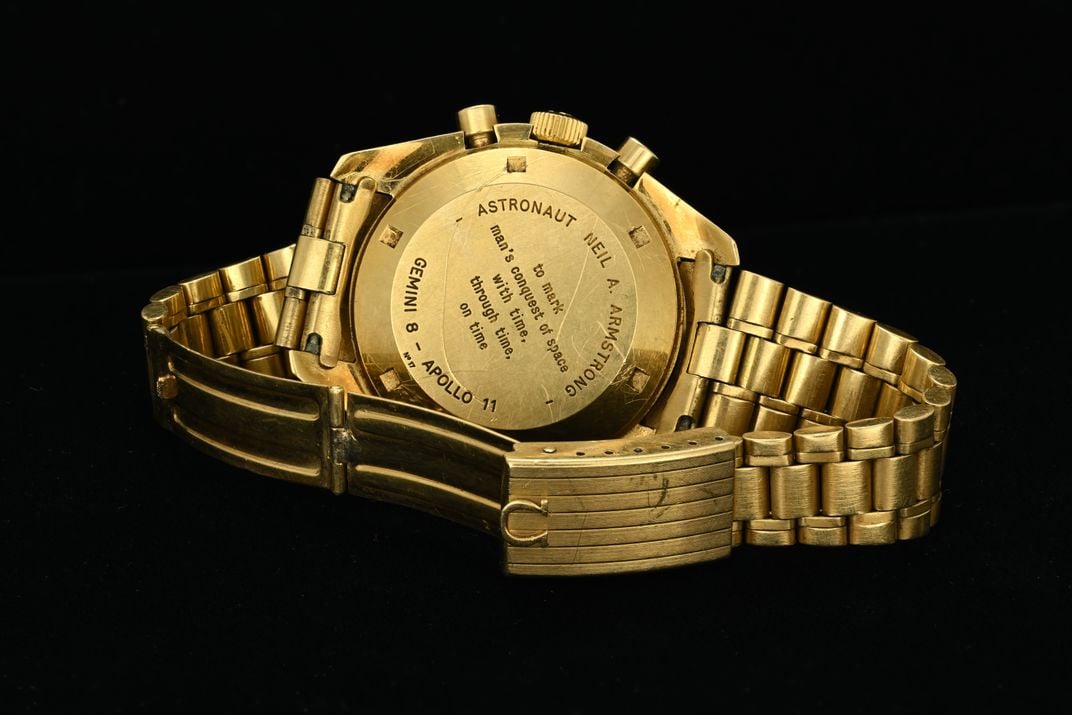 Back of gold watch with engraving