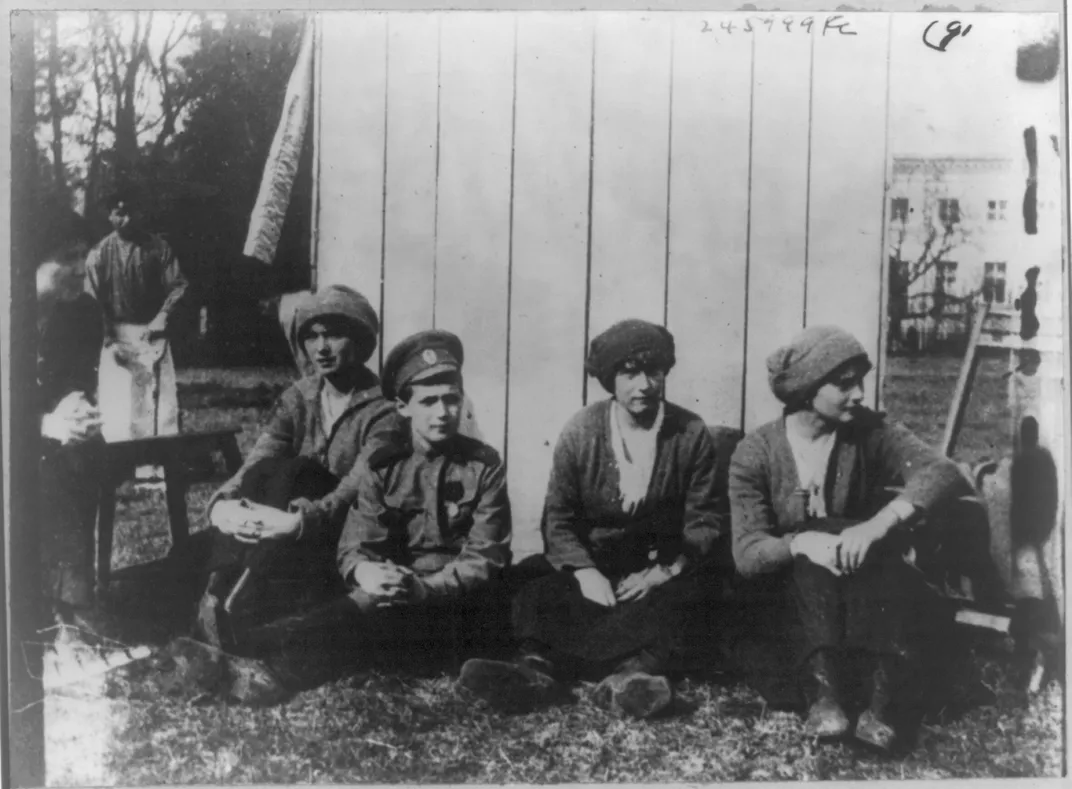 Olga, Alexei, Anastasia and Tatiana rest after working in the garden in 1917.