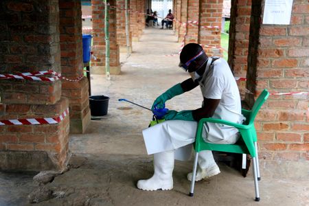 A health care worker wears virus protective gear at a treatment center in Bikoro, Democratic Republic of Congo, the epicenter of the latest outbreak.