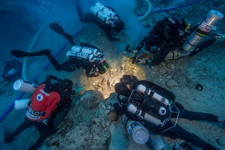 Archaeologists excavating the Antikythera Shipwreck skeletal remains.