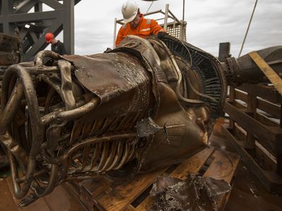 Workers clean the salvaged F-1 engine