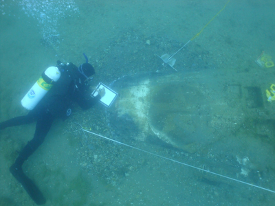 Researchers study wreckage from Moody&#39;s P-39 aircraft, which lies in pieces on the floor of Lake Huron.