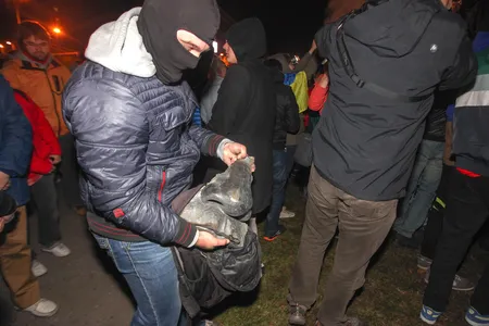 A protester holds the cut off nose of the statue of former Soviet leader Vladimir Lenin after it was toppled during a rally on the central square of eastern Ukrainian city of Kharkiv, 28 September 2014.