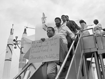 Reverend Ralph Abernathy, Hosea Williams, and other members of the SCLC Poor People's Campaign march through the lunar lander exhibit at Kennedy Space Center before the launch of Apollo 11.