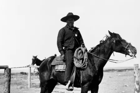 An African-American cowboy sits saddled on his horse in Pocatello, Idaho in 1903. 