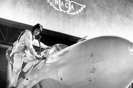 Test pilot Lawrence Clousing with a Lockheed P-80, Moffett Field, California, 1948. Note the NACA emblem, with no periods, on the wall of the Ames Aeronautical Laboratory. 