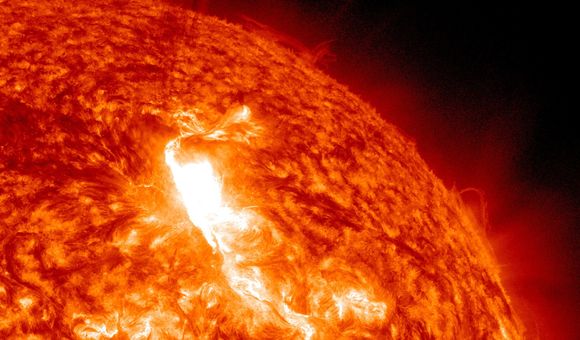 A solar flare erupting from the sun in deep space.