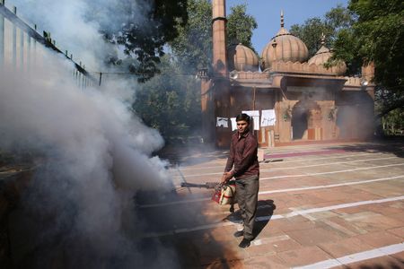 An Indian Municipal Corporation sanitation worker fumigates as part of a drive to curb breeding sites for mosquitoes causing a dengue outbreak in New Delhi in October 2015.