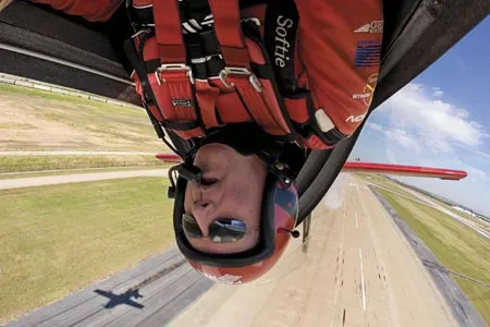 Head games: Fierce concentration is what keeps airshow pilot Greg Poe from knocking his noggin during a low inverted pass. With equal focus, Poe and other aerobatic pilots control their aircraft even during the most chaotic tumbles.