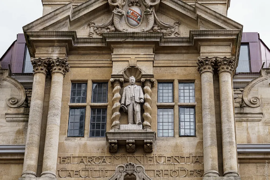 Statue of Rhodes on side of college building