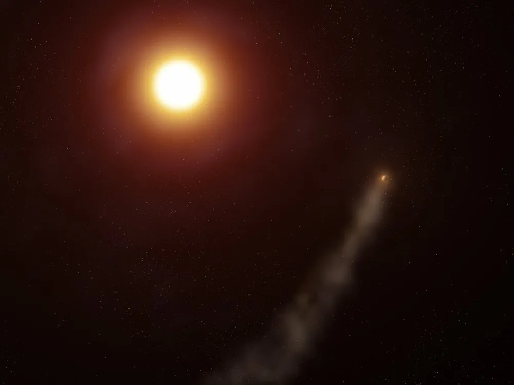 An image of a planet with a tail of gas behind it circling a sun