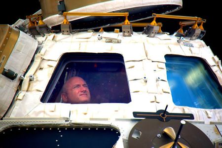 Kelly sightseeing at the space station Cupola windows.