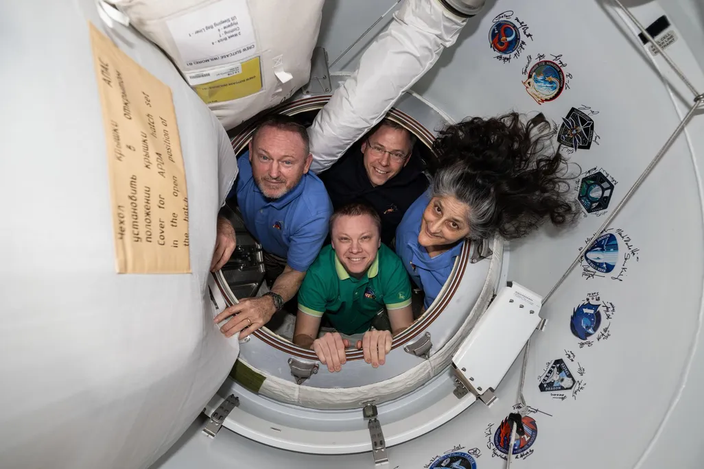 Four astronauts posing for a photo