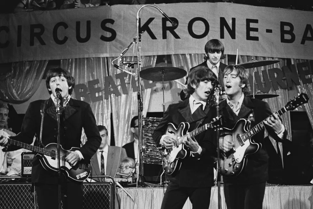 The Beatles perform on stage
