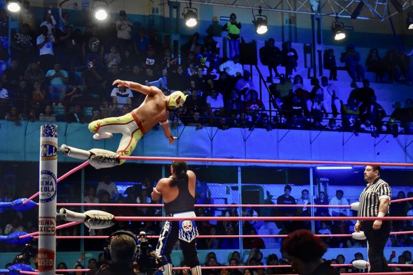 A Mexican "Lucha Libre" contestant attacks his opponent by jumping off the ropes thumbnail