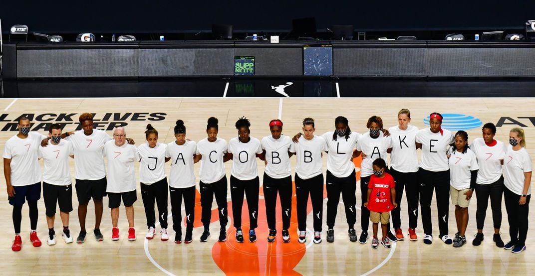 The Washington Mystics each wear white T-shirts with seven bullets on the back protesting the shooting of Jacob Blake by Kenosha, Wisconsin police at Feld Entertainment Center