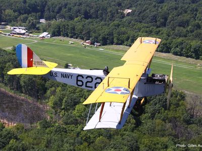 A Curtiss JN-4H chugs over Old Rhinebeck Aerodrome, one of the few sites where you can see World War I replicas fly. 