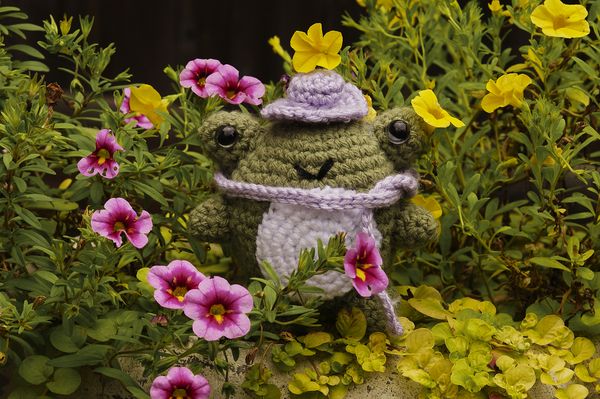 Crocheted frog in bed of flowers thumbnail