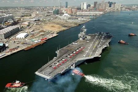 050519-N-8704K-001 Boston Mass. (19 May 2005) USS John F Kennedy (CV 67) makes her way into historic Boston Harbor as John F Kennedy Strike Group Sailors form up to spell "JACK IS BACK" with Marine Expeditionary Unit Two Four  (MUE 24) manning the rails.  Kennedy and MUE 24 are in Boston Massachusetts for a scheduled port visit.. US Navy photo by Photographers Mate Third Class (AW/SW) Joshua Karsten. (RELEASED)