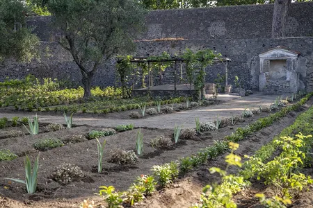 The garden features a reconstructed shaded alcove for dining.