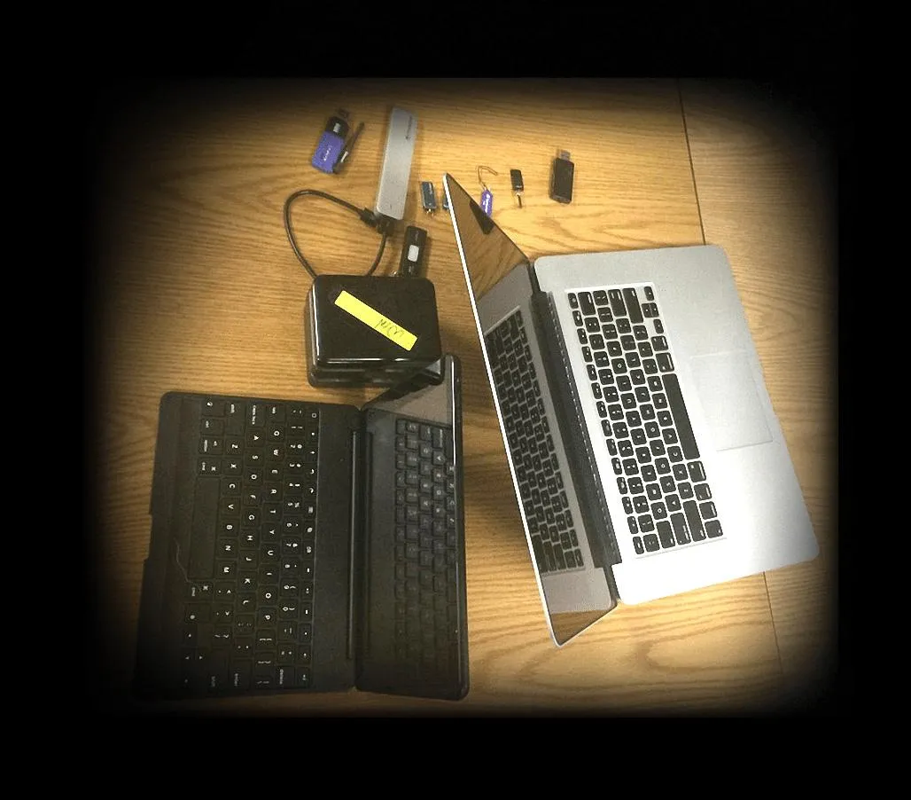 a laptop and hard drives on a table