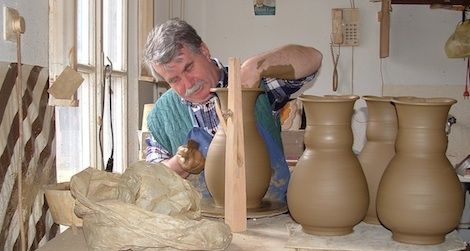 A professional potter works on his craft in Mezőtúr, Hungary, a town known for its traditional pottery-making.