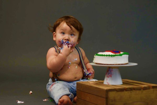 Adorable kid eating cake.  thumbnail