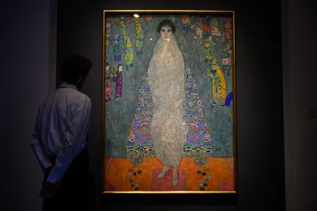 An art handler stands in front of Portrait of Elisabeth Lederer&nbsp;by Gustav Klimt during a press preview at Sotheby's on November 7.
