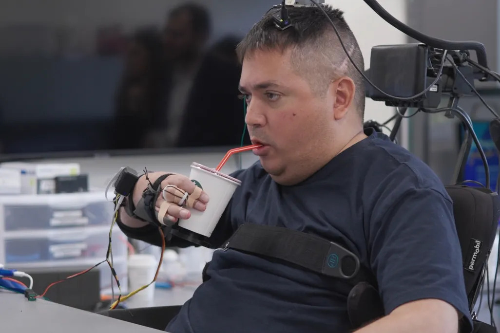 Keith Thomas lifting and drinking from a cup