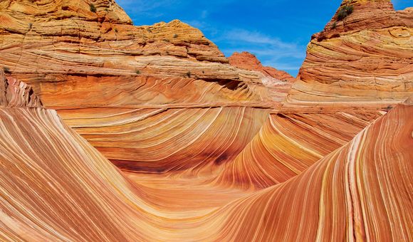 A stunning landscape featuring a wavy sandstone rock formation