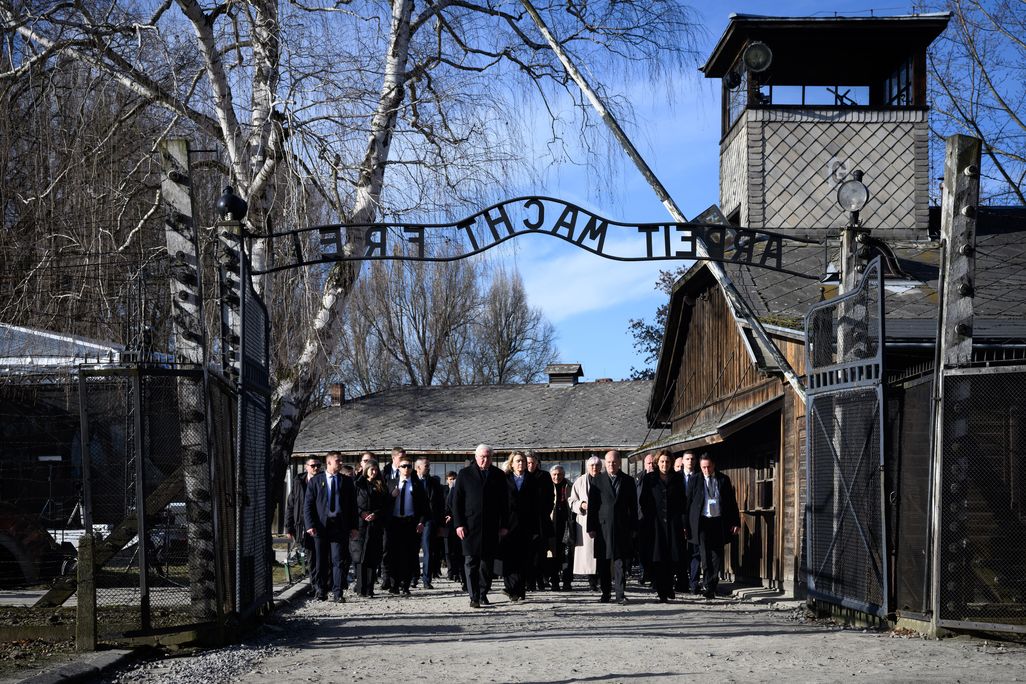 Group of people walking under a gate