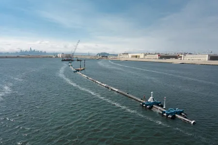 The device is designed to function as an artificial shoreline, drifting with ocean currents and collecting plastic in a 10-foot net-like screen