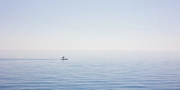 A paddle-boarder wadding across Lake Michigan thumbnail