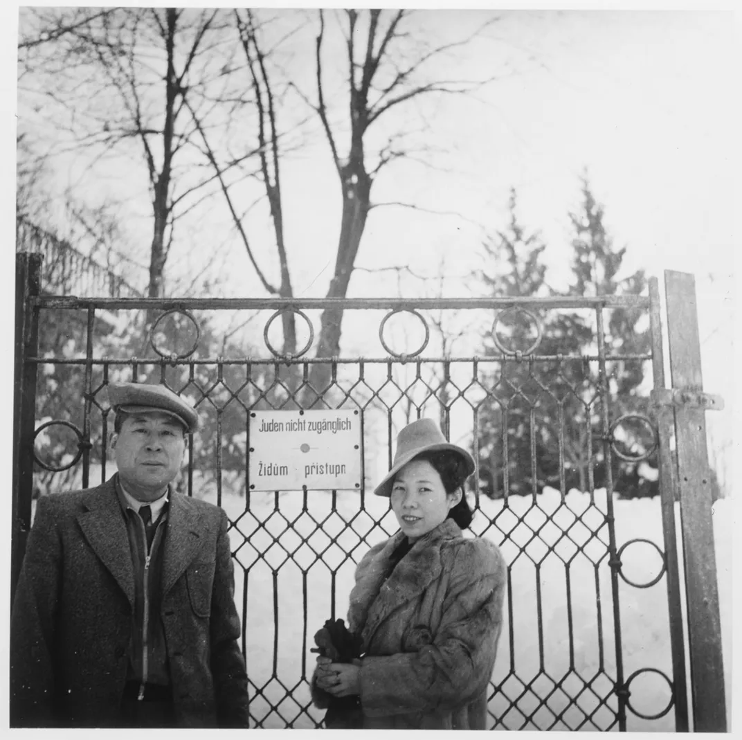 Chiune Sugihara and his wife Yukiko pose in front of the gate to a park in Prague in 1940 or 1941
