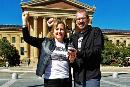 Larissa and Michael Milne, shown here in their hometown of Philadelphia, sold nearly all their belongings in 2011 and embarked on a tour of the world. Along the way they visited the frightening but fascinating country of North Korea. Also shown in this photo is the Milnes’ travel companion, “Little Rocky,” a six-inch figurine of one of Philadelphia’s most famous native sons.