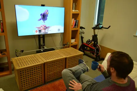 Researcher Christopher Clarke controls a TV with his coffee cup.