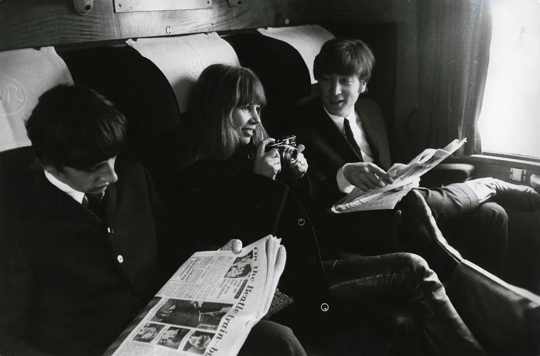L to R: Ringo Starr, Astrid Kirchherr and John Lennon sitting on train during the filming of <em>A Hard Day's Night</em>