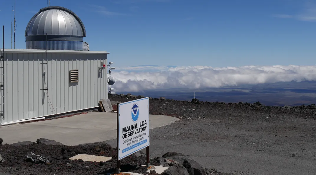 an observatory on a mountain above the clouds