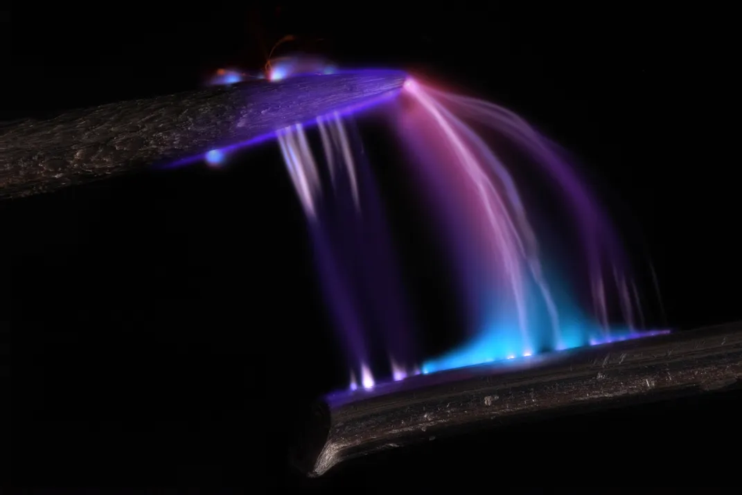 Purple and blue light between two objects