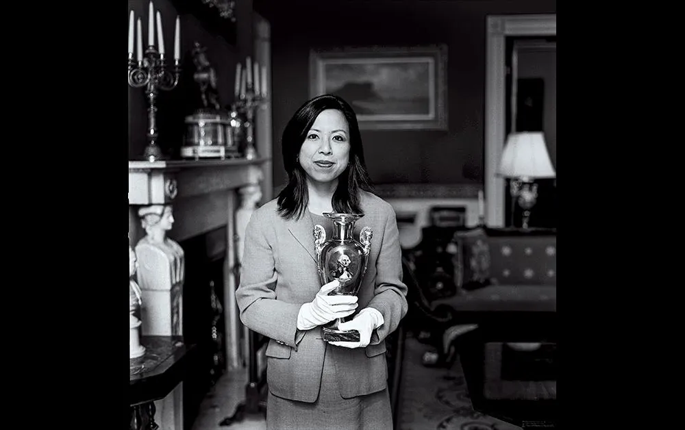 SM_Donna Hayashi Smith, a curator holding a French porcelain vase from 1820.