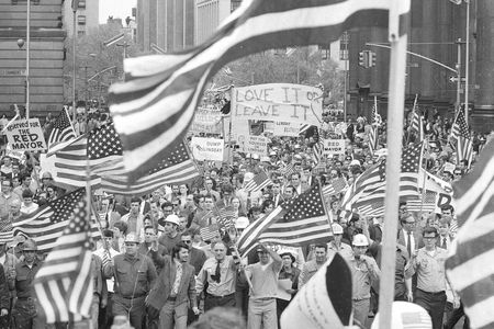 New York workers, angered by the Mayor's apparent anti-Vietnam-War sympathies, wave American flags as they march in a demonstration near City Hall in New York City on May 15, 1970.