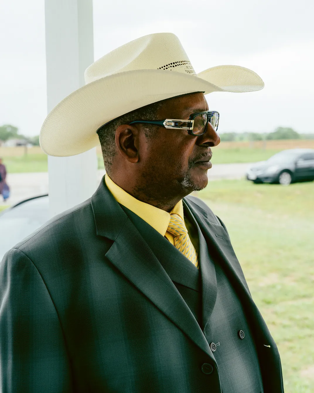 a man wears a white cowboy hat