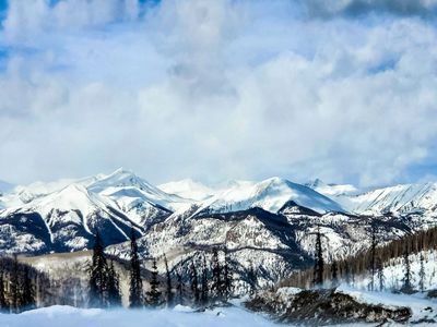 The snow-capped Rockies glow bright white in the snow.