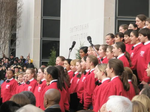 The children's chorus performing outside the museum
