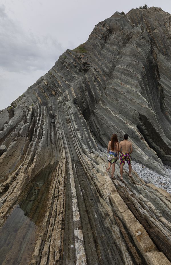 A couple of bathers enter the flysch of Sopelana beach thumbnail