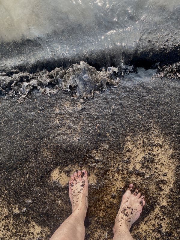 Canadian wildfire debris on my toes in Lake Michigan thumbnail