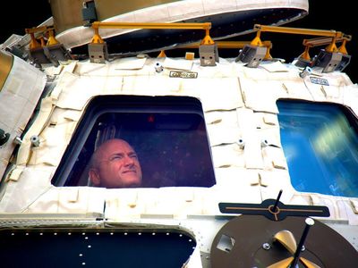 Kelly sightseeing at the space station Cupola windows.