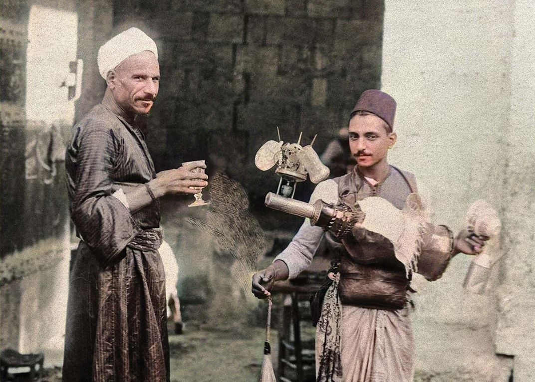 a lemonade vendor and a customer pose for a photograph in Egypt